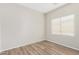Bright bedroom with wood-look floors and window at 10722 W Jefferson St, Avondale, AZ 85323