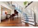 Unique spiral staircase with glass and metal accents, next to a grand piano at 341 E Monte Vista Rd, Phoenix, AZ 85004