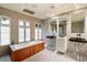 Modern bathroom with a freestanding tub, patterned tile, and dual sinks at 341 E Monte Vista Rd, Phoenix, AZ 85004
