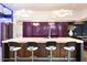 Modern kitchen with purple island, breakfast bar, and unique lighting fixtures at 341 E Monte Vista Rd, Phoenix, AZ 85004