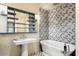 Modern bathroom with a freestanding tub and patterned tile at 341 E Monte Vista Rd, Phoenix, AZ 85004