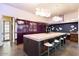 Modern kitchen with purple cabinetry, marble countertops, and breakfast bar at 341 E Monte Vista Rd, Phoenix, AZ 85004
