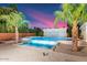 Relaxing pool and spa area with palm trees and a waterfall feature at 341 E Monte Vista Rd, Phoenix, AZ 85004
