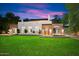 Brick home with a large grassy yard, inviting front entrance, and lush landscaping at 341 E Monte Vista Rd, Phoenix, AZ 85004