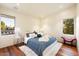Spacious bedroom with hardwood floors, large windows, and comfortable bedding at 341 E Monte Vista Rd, Phoenix, AZ 85004