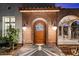 Close-up of the charming brick entryway with arched door at 341 E Monte Vista Rd, Phoenix, AZ 85004