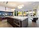 Modern kitchen with large island, purple appliances, and glass doors opening to backyard at 341 E Monte Vista Rd, Phoenix, AZ 85004