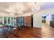 Spacious dining room with glass table, brick wall, and chandelier at 341 E Monte Vista Rd, Phoenix, AZ 85004