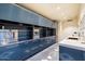 Long, sleek outdoor kitchen with stainless steel appliances and blue cabinetry at 341 E Monte Vista Rd, Phoenix, AZ 85004