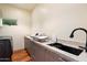 Bright laundry room with modern finishes and plenty of counter space at 341 E Monte Vista Rd, Phoenix, AZ 85004