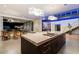 Open concept kitchen with large island, modern lighting, and views to backyard at 341 E Monte Vista Rd, Phoenix, AZ 85004