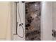 Spa-like shower with a marble and mosaic tile design at 341 E Monte Vista Rd, Phoenix, AZ 85004