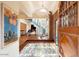 Grand entryway with a unique floor, exposed brick wall, and a wooden door at 341 E Monte Vista Rd, Phoenix, AZ 85004