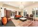 Spacious living room featuring exposed brick and a stunning chandelier at 341 E Monte Vista Rd, Phoenix, AZ 85004