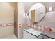 Elegant bathroom with a large round mirror, glass sink, and patterned tile at 341 E Monte Vista Rd, Phoenix, AZ 85004