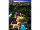 Aerial view of a beautiful property at dusk showcasing a large pool and city skyline at 341 E Monte Vista Rd, Phoenix, AZ 85004