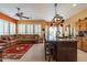 Open kitchen with island, copper pot rack, and leather seating at 4333 S Pony Rider Trl, Gold Canyon, AZ 85118