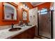 Bright bathroom with double vanity, copper sinks, and a separate shower at 4333 S Pony Rider Trl, Gold Canyon, AZ 85118
