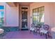 Inviting front porch with wrought iron chairs and small table at 4333 S Pony Rider Trl, Gold Canyon, AZ 85118