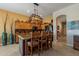 Kitchen with granite island, wood cabinets, and a charming copper pot rack at 4333 S Pony Rider Trl, Gold Canyon, AZ 85118