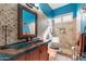 Bathroom with single copper sink, blue tile, and a shower/tub combo at 4333 S Pony Rider Trl, Gold Canyon, AZ 85118