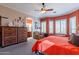 Bright bedroom with king bed, ceiling fan, and en-suite bathroom access at 4333 S Pony Rider Trl, Gold Canyon, AZ 85118