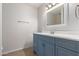 Updated bathroom with blue vanity and a large mirror at 1966 E Oxford Dr, Tempe, AZ 85283