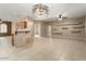 Open living room with tile floors, built-in shelving, and a modern chandelier at 21438 N Olmsted Point Ln, Surprise, AZ 85387