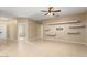 Bright living room with tile floors and built-in shelving at 21438 N Olmsted Point Ln, Surprise, AZ 85387