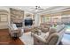 Relaxing living room with fireplace, hardwood floors, and access to backyard at 18119 W Narramore Rd, Goodyear, AZ 85338