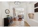 Elegant entryway with tiled floors and a dark wood console table at 18119 W Narramore Rd, Goodyear, AZ 85338