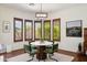 Bright breakfast nook with a round table, green chairs, and window seating at 18119 W Narramore Rd, Goodyear, AZ 85338