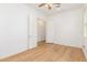 Light and airy bedroom with wood floors and access to a walk-in closet at 3132 E Austin Dr, Gilbert, AZ 85296