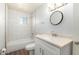 Updated bathroom with white tile and a modern vanity at 8126 E Broadway Rd, Mesa, AZ 85208