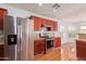 Kitchen features wood cabinets, granite counters, and stainless steel appliances at 18337 W Stinson Dr, Surprise, AZ 85374