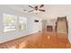 Bright living room with wood-look floors, large windows, and a staircase at 18337 W Stinson Dr, Surprise, AZ 85374