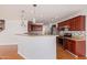 Modern kitchen with granite counters and wood cabinets at 18337 W Stinson Dr, Surprise, AZ 85374