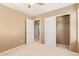 Bedroom with double door closet and access to hallway at 18337 W Stinson Dr, Surprise, AZ 85374