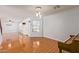 Open living room with wood-look floors and a view of the kitchen at 18337 W Stinson Dr, Surprise, AZ 85374
