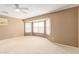 Main bedroom with bay window and ceiling fan at 18337 W Stinson Dr, Surprise, AZ 85374