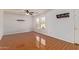Living area with wood-look floors, ceiling fan and window at 18337 W Stinson Dr, Surprise, AZ 85374