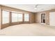 Main bedroom with bay window and ceiling fan at 18337 W Stinson Dr, Surprise, AZ 85374