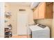 Bright laundry room with washer, dryer, and ample cabinet storage at 5389 S Scott Pl, Chandler, AZ 85249