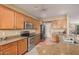 Kitchen with stainless steel appliances and wood cabinets at 5389 S Scott Pl, Chandler, AZ 85249