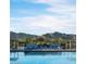 Stunning community pool with mountain views and lounge chairs at 12315 W Parkway Ln, Avondale, AZ 85323