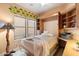 Comfortable bedroom/office with a Murphy bed, built-in shelves, and a desk at 7473 E Soaring Eagle Way, Scottsdale, AZ 85266