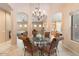 Formal dining room featuring a glass-top table and chandelier at 7473 E Soaring Eagle Way, Scottsdale, AZ 85266