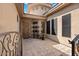 Private courtyard entry with tile flooring and wrought iron gate at 7473 E Soaring Eagle Way, Scottsdale, AZ 85266