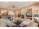 Spacious living room features a fireplace and views into the kitchen and dining area at 7473 E Soaring Eagle Way, Scottsdale, AZ 85266