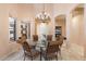 Bright dining room with glass-top table and chandelier at 7473 E Soaring Eagle Way, Scottsdale, AZ 85266